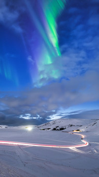 Aurora Borealis in Iceland. Northern Lights over the road