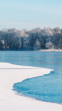 Wonderful white winter landscape with frozen lake