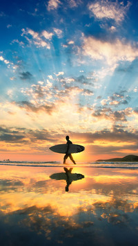 A man is walking with a surf across the shore