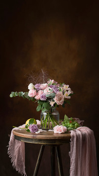 Rose in Glass Bottle on Wooden Table