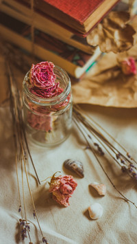 Close-up of dried rose flowers in a glass cup