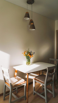 White table with bouquet of flowers and chairs