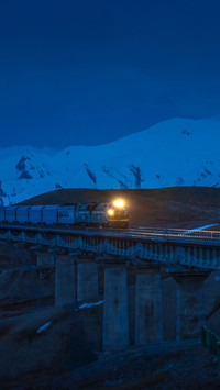 China Railway train under the snow-capped Jade Everest