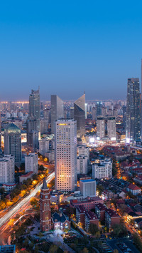 Twilight shines through the city's light and shadow.