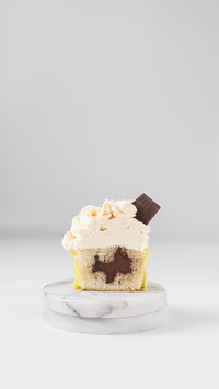 Chocolate filled vanilla cupcake with white frosting