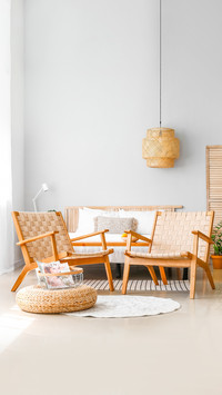 Interior of modern bedroom with wicker armchairs