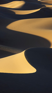 Sahara desert sand dunes with dark shadows at Erg Lihoudi