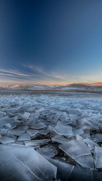 Ice cracks mirror mountain views