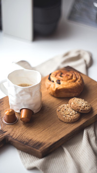 Drinking coffee with a muffin in the morning daylight