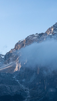 Snowy peaks bathed in clear sunlight, embracing the scenic b