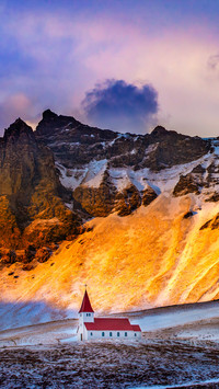 Kurkirka church against the snowy mountains