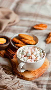 Warm cozy bedroom interior with cup of hot chocolate on tray