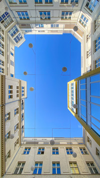 courtyard of apartment block against blue sky