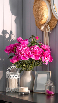A beautiful pink peony bouquet on a table in the sunlight