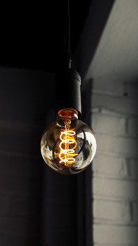 Industrial lightbulb with bright glow and dark background