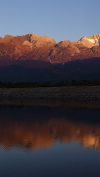 Jade Dragon Snow Mountain bathed in sunlight, turning golden