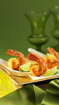 Crispy prawns with lime wedges