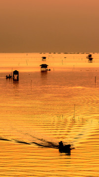 Hut on the sea and boat during morning sunrise