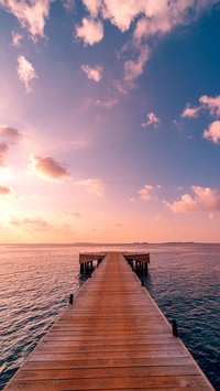 Beautiful seascape long jetty pier at sunset
