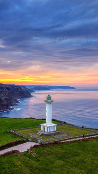 The Lastres lighthouse at sunset in the town of Luces