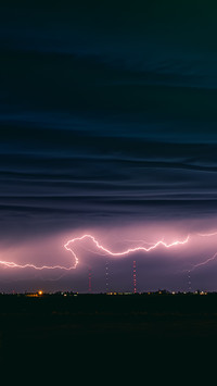 View of lightning strike over a rural farm field