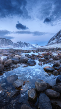 Seashore with stones and blurred water