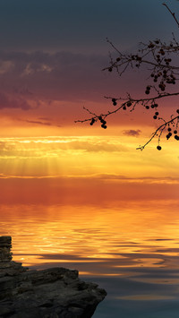 Sunset in the sea rocks calm and beautiful