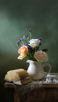 Romantic still life with a bouquet of roses and a book