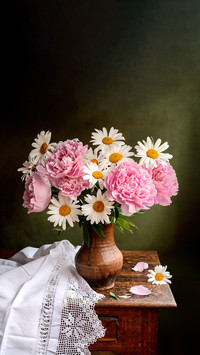 Still life with flowers of peonies on a table