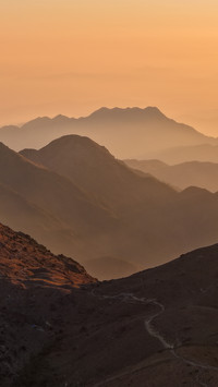 The golden morning glow layers upon the mountains