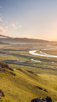 The morning light of the grassland tints the small town
