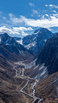 The road under the snowcapped mountains