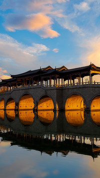 The sun rises over lingyun bridge with golden light
