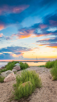 Father and son enjoying the sunset on the Baltic Sea beach