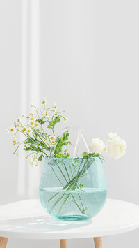 A Bunch of White Flowers Inserted in the Blue Glass Bottle