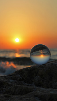 reflection of the sky and the sea in a glass bowl