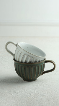 Pottery cups on white background