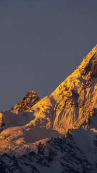 The Meili Snow Mountain is dazzling with golden light