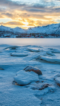 Breathtaking sunset over frozen lake like a painting.