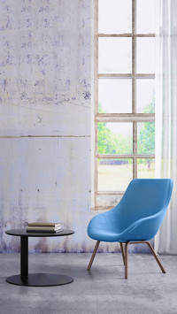 Pastel colored armchair with coffee table window and