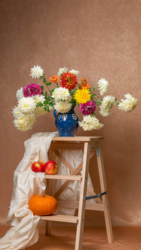 A large bouquet of dahlias on a wooden staircase