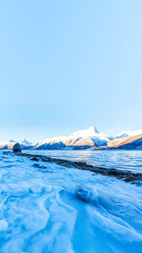 Beautiful winter landscape with icy shore of the fjord