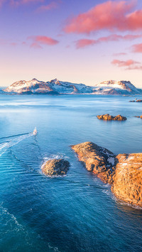 Aerial view of fishing boats, rocks in the blue sea