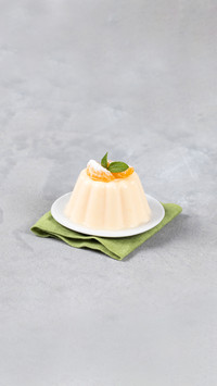 Creamy tangerine pudding on a plate on a linen napkin