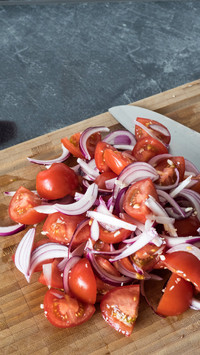 High angle view of tomatoes and onions on cutting board