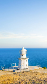 Small white lighthouse on a marine cape