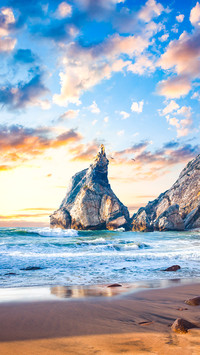 Fantastic big rocks and stones on the ocean beach at sundown