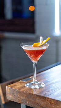 Cosmopolitan cocktail on wooden table