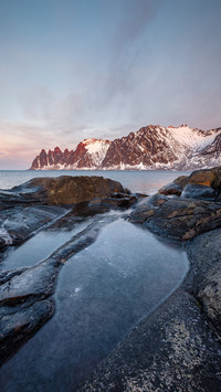 Frozen rockpool between rocks in norway