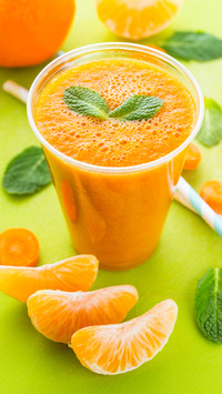 Carrot orange turmeric smoothie with mint leaves